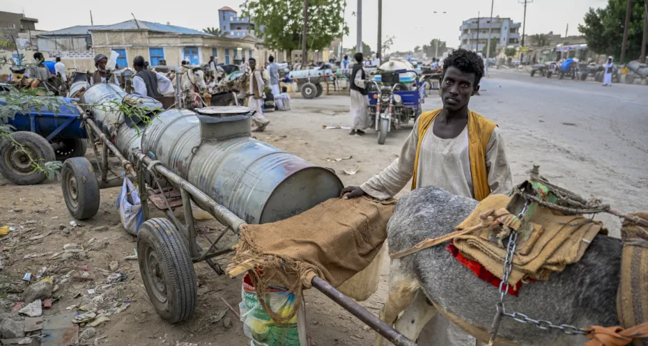 People queue to refill donkey-drawn water tanks during a water crisis in Port Sudan, in war-torn Sudan. The war between Sudan's army and a paramilitary force since April 2023 has killed tens of thousands and forced millions to flee their homes.