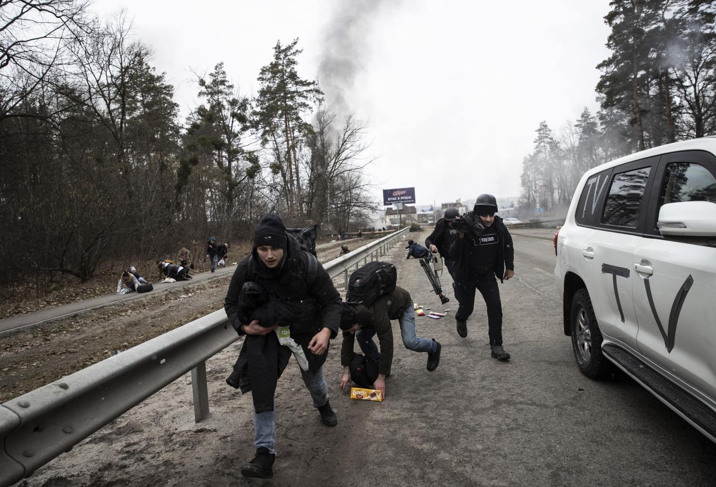 Journalists running for safety in Ukraine. Photo: Anna Dolu Agency