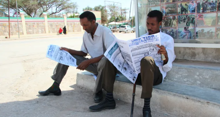 Two man with newspapers