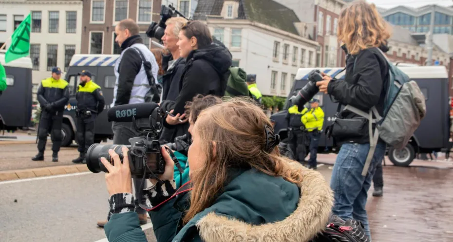 Journalist at work during demonstration in the Netherlands