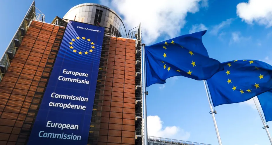 European Union flags waving in wind in front of European Commission building. Brussels, Belgium.
