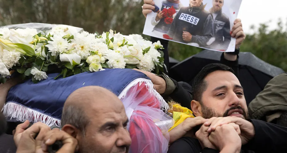 ournalist Fatima Ftouni to her burial spot during a funeral held for three journalists killed in an Israeli strike on March 29, 2026 in Choueifat,