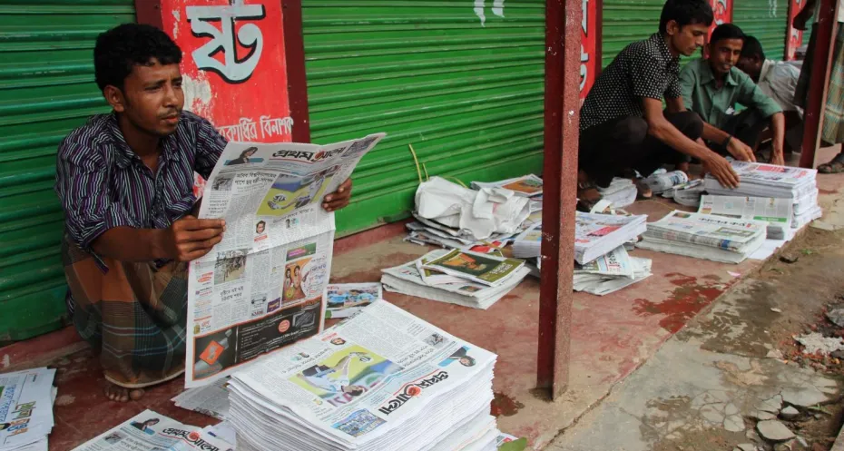 Man reading one of the newspapers in Bangladesh 