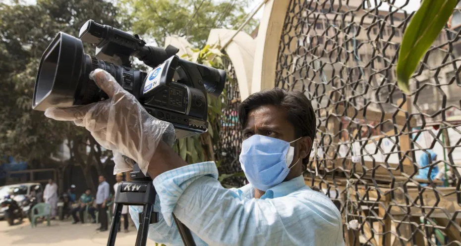 Bangladeshi journalist with face mask works amid coronavirus 