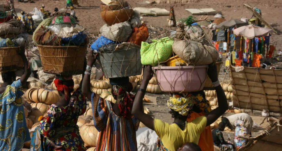 Pictures of the landscape of Mali. Women carry baskets on their heads.