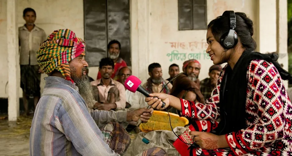 Men being interviewed by a reporter from Radio Chilmari
