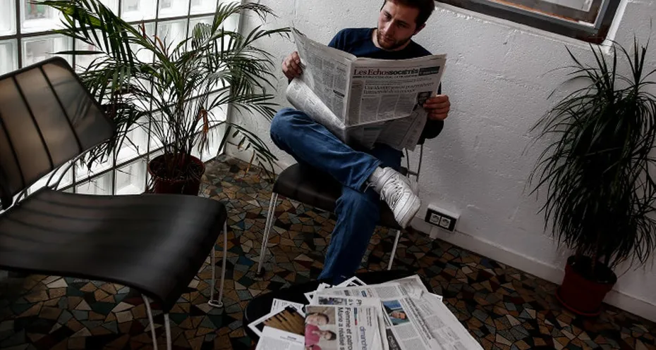 Syrian reads newspaper