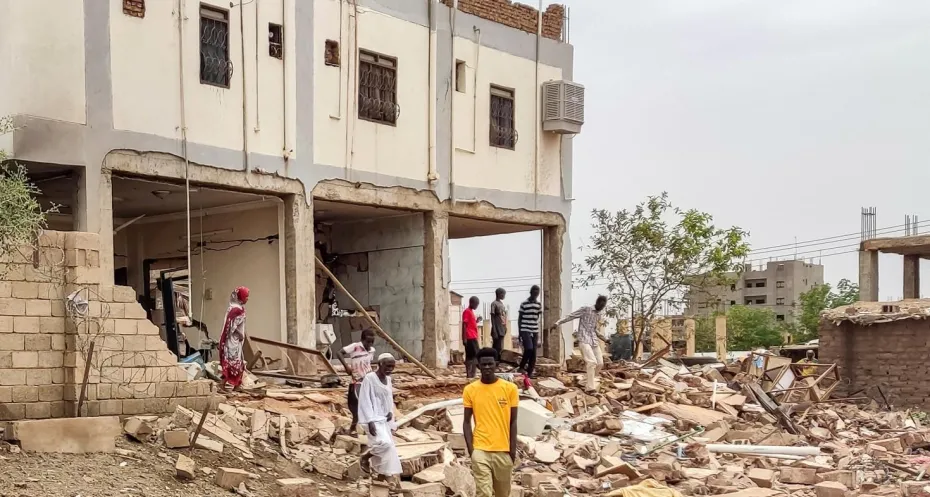 People at a house that was hit by an artillery shell in the south of Khartoum on June 6, 2023 - AFP